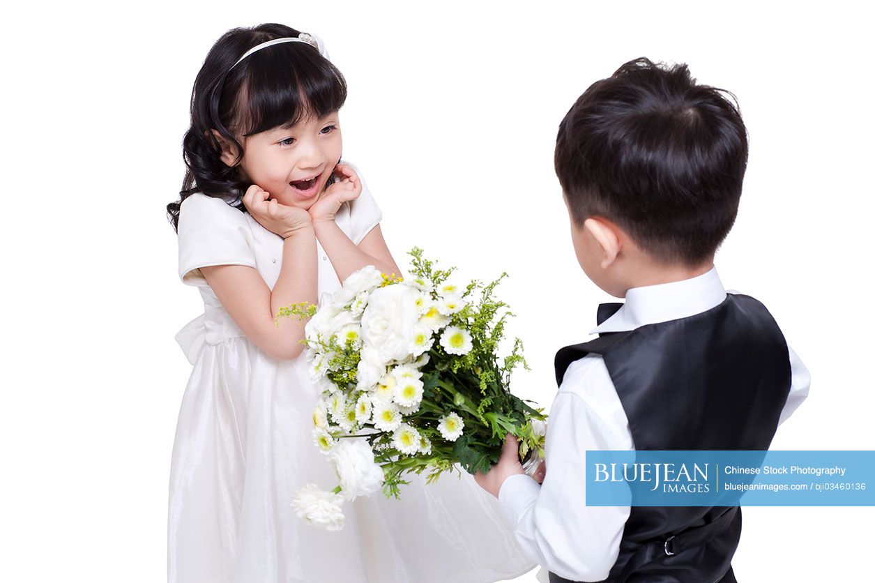 Lovely Chinese boy giving flowers to girl