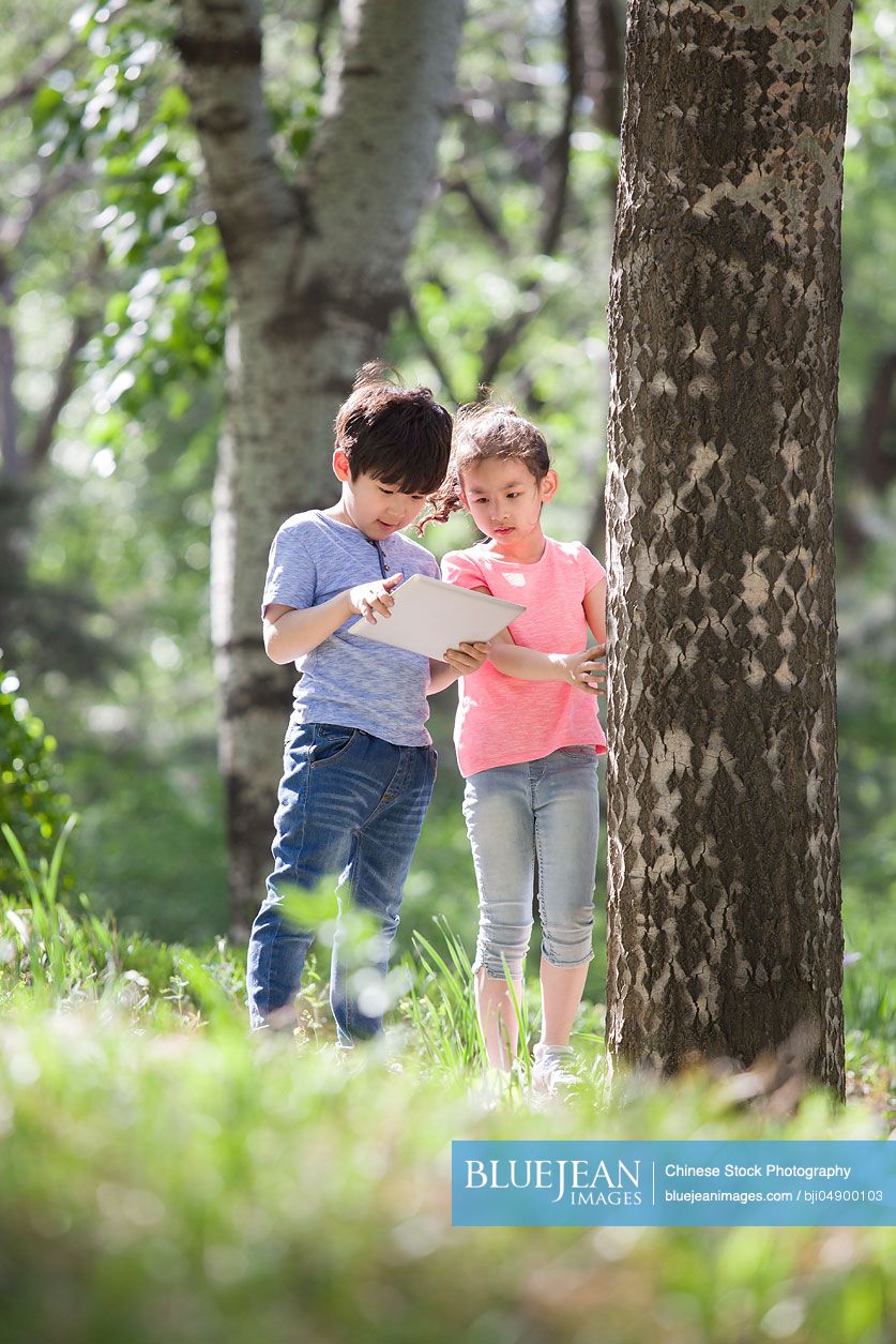 Happy Chinese children playing in woods