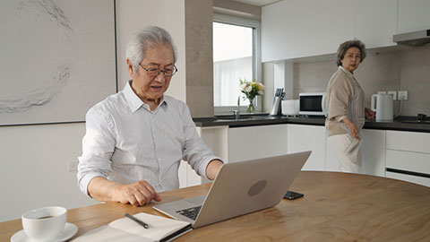 Senior Chinese couple  using laptop and cell phone,4K