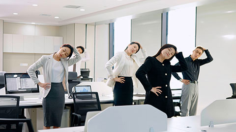 Chinese business people exercising in office