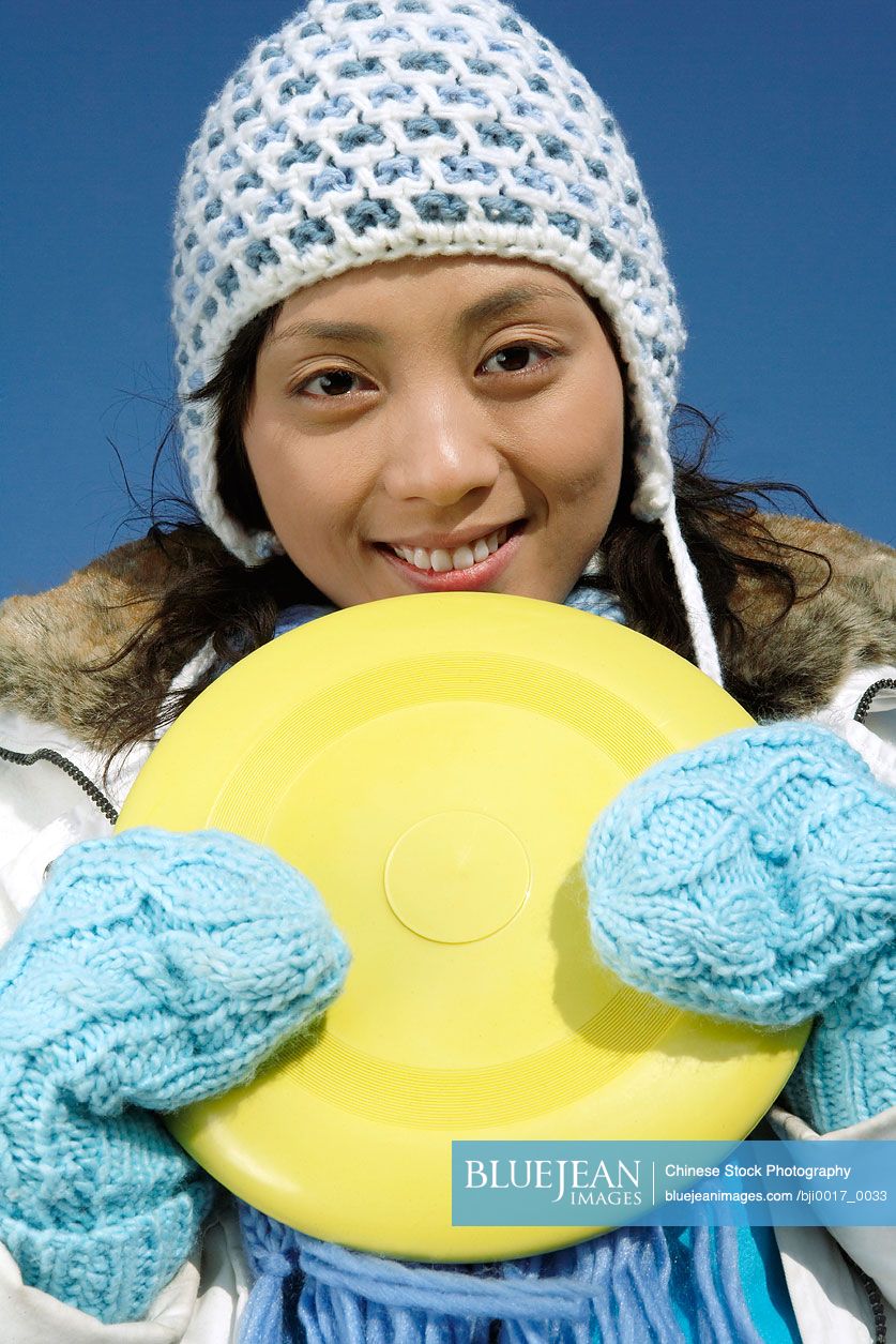 Young Chinese Woman On The Great Wall Of China Holding A Frisbee