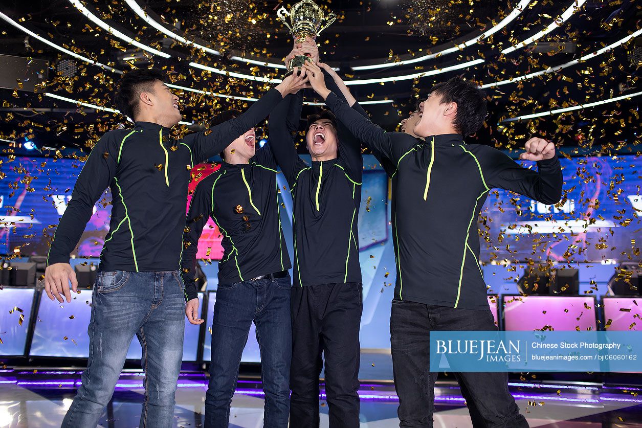 Young Chinese men winning esports competition