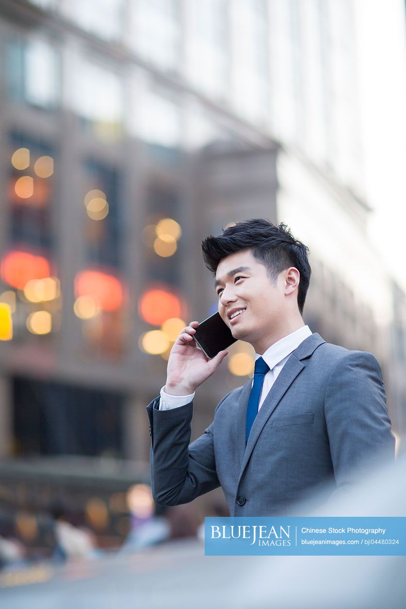 Young Chinese businessman talking on the phone