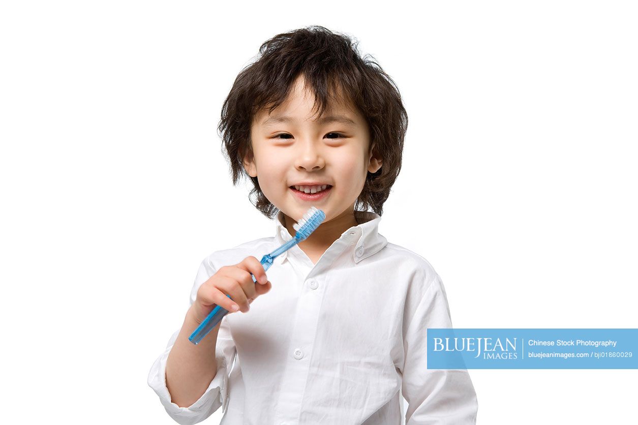 Little Chinese boy brushing teeth