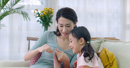 Happy Chinese mother and daughter knitting at home,4K
