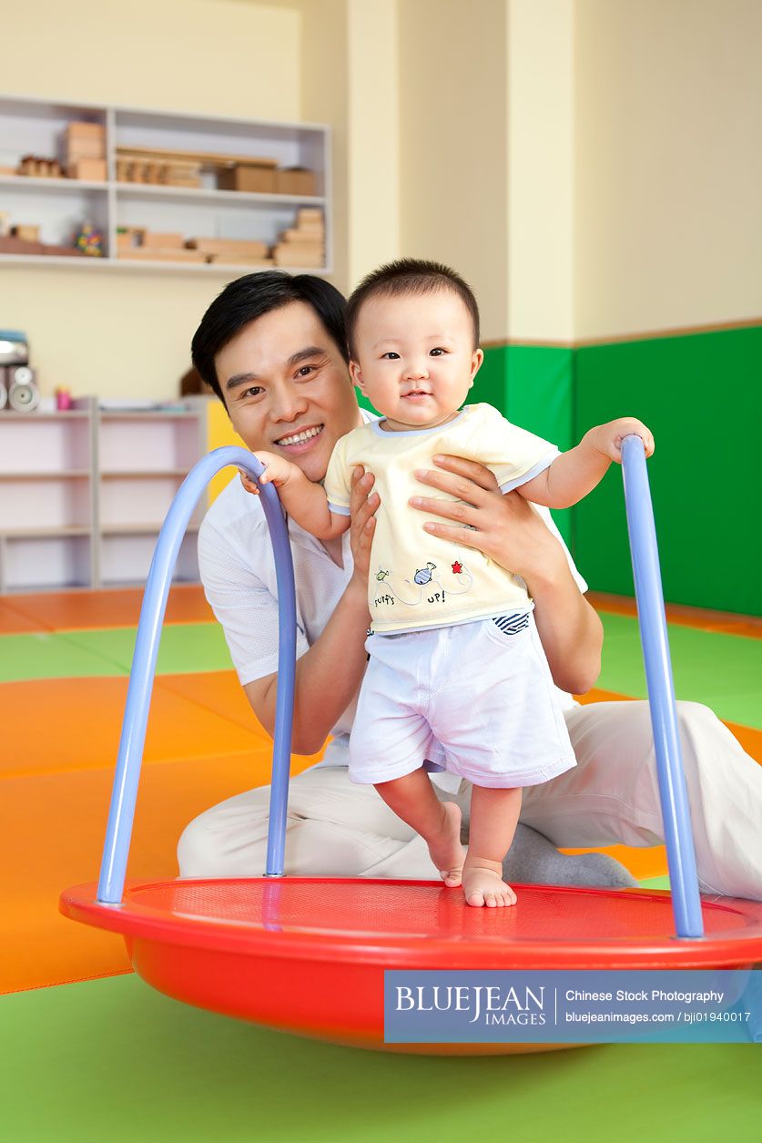 Chinese father playing with son