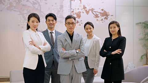 Confident Chinese business people standing in office