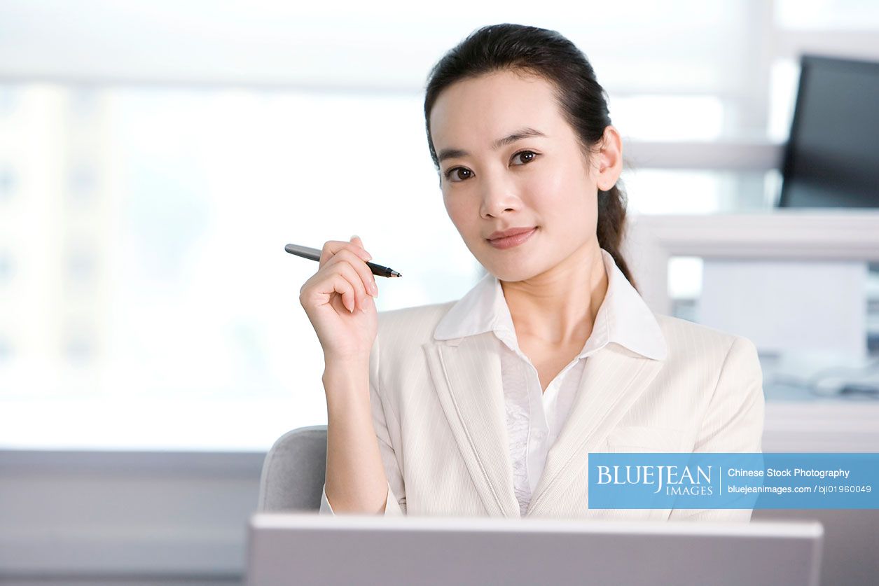 Chinese office worker at her desk