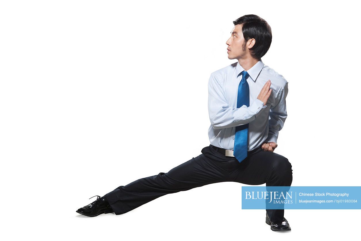Chinese businessman crouching in martial arts position