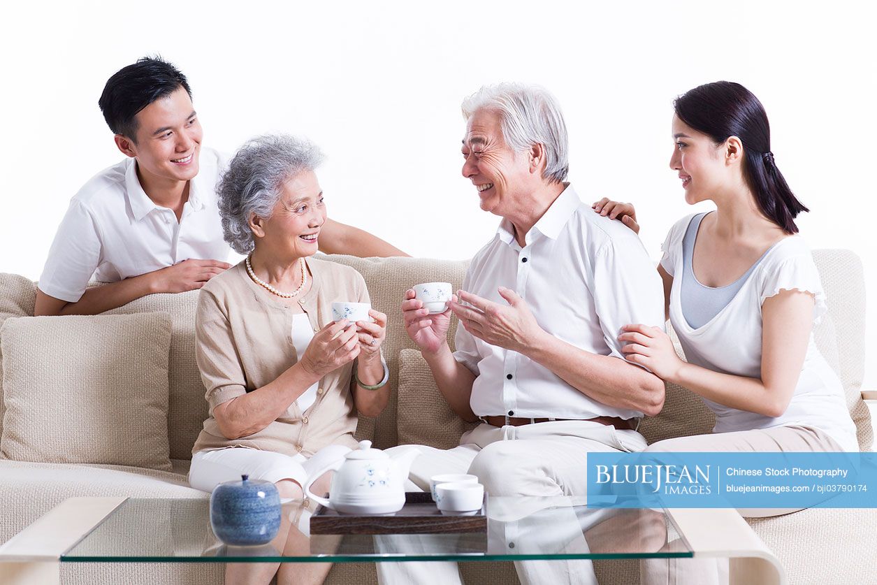 Happy Chinese family having tea and chatting