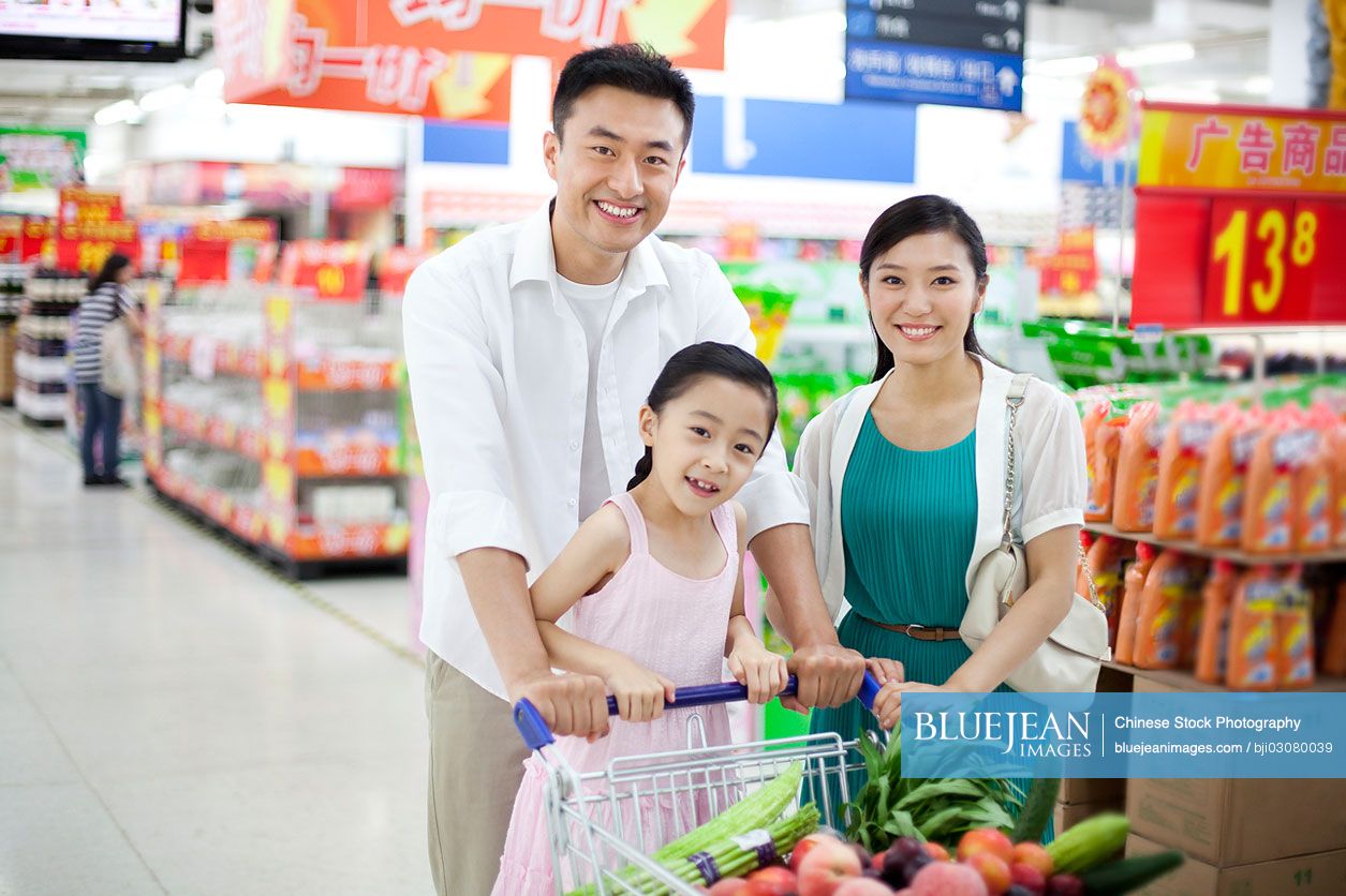 Chinese family shopping in supermarket