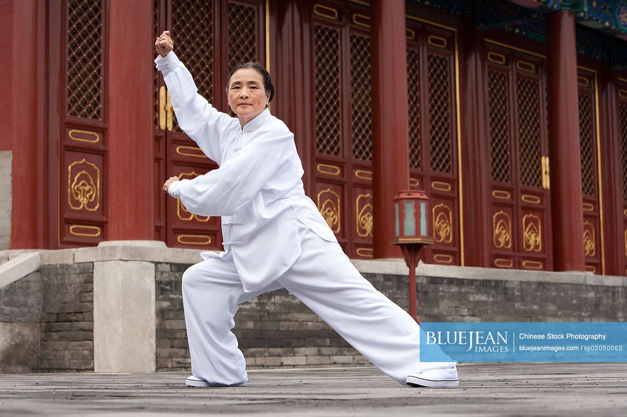 Senior Chinese woman practicing Tai Chi in Temple of Heaven
