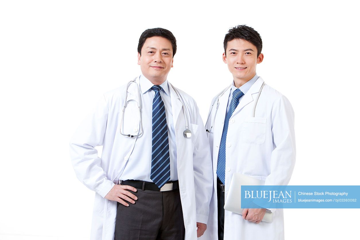Portrait of two professional male Chinese doctors with digital tablet