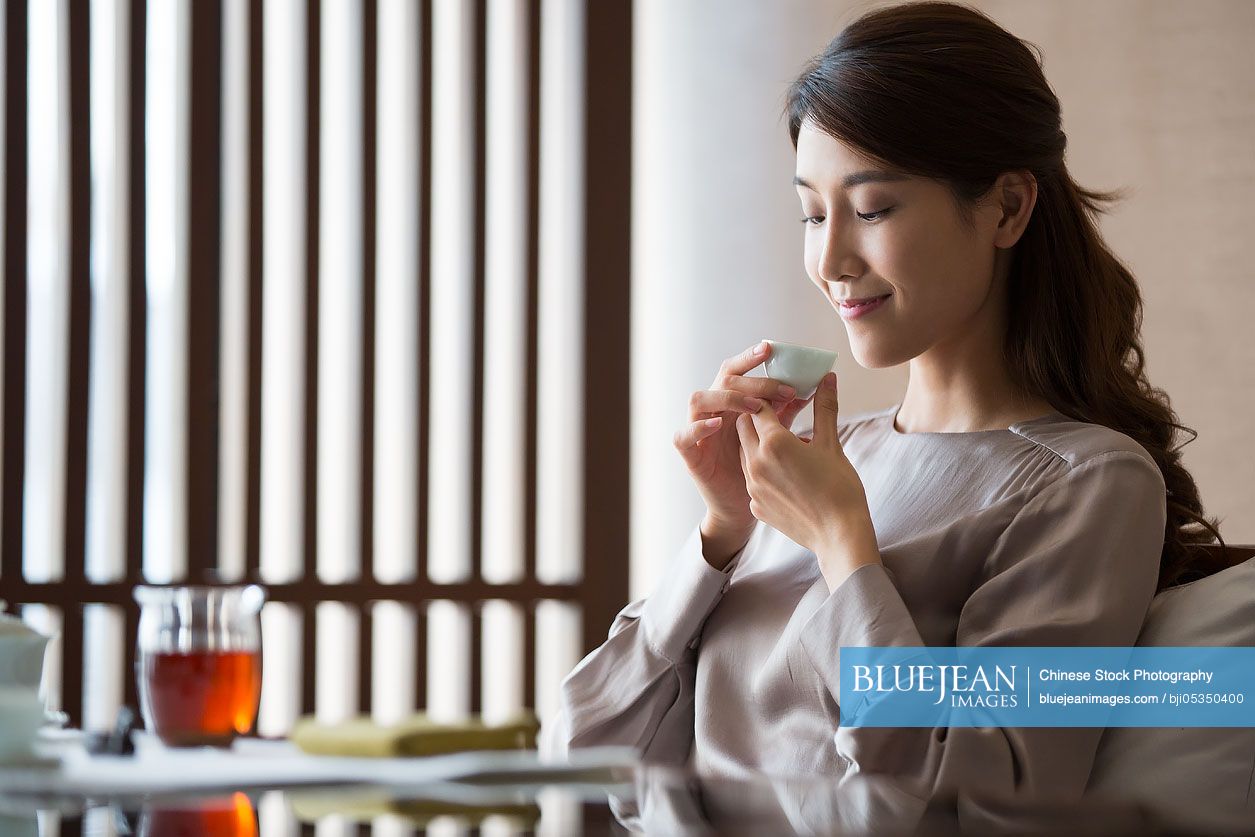 Young Chinese woman drinking tea