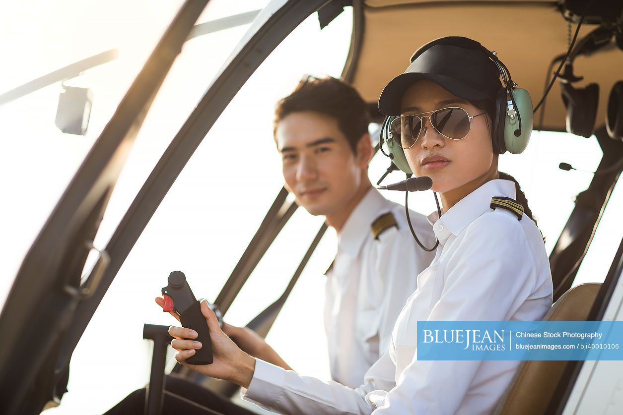 Chinese pilots sitting in helicopter cockpit