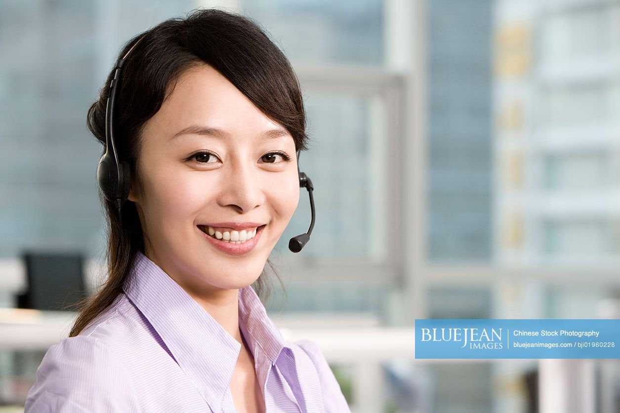 Chinese office worker with a headset