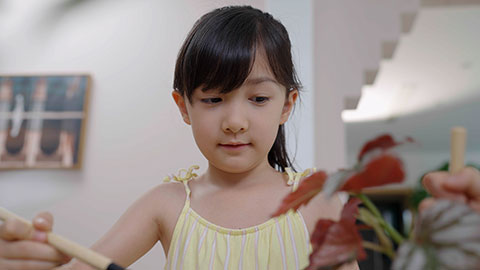 Girl and boy enjoy potting plants together at home