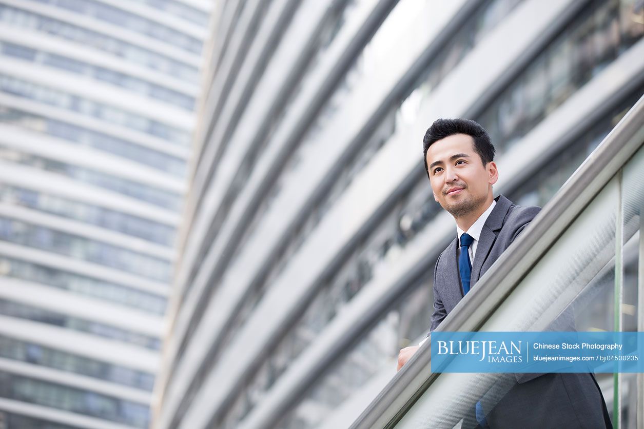 Chinese businessman looking at view thinking