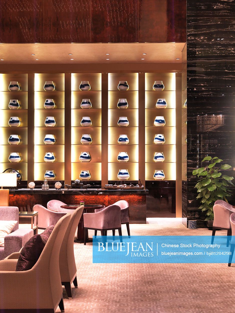 Seating arrangements with centerpieces in shelf at elegant hotel lobby