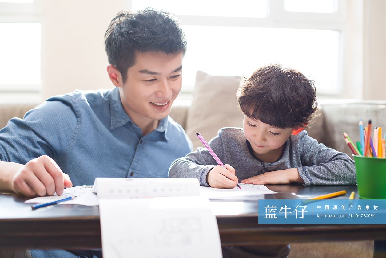 年轻父亲指导儿子做作业