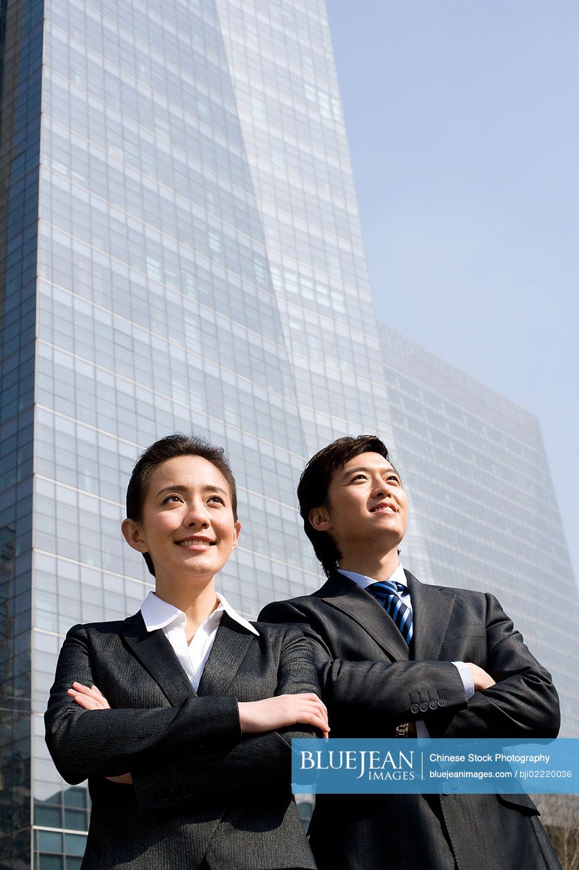 Chinese business partners standing confidently together