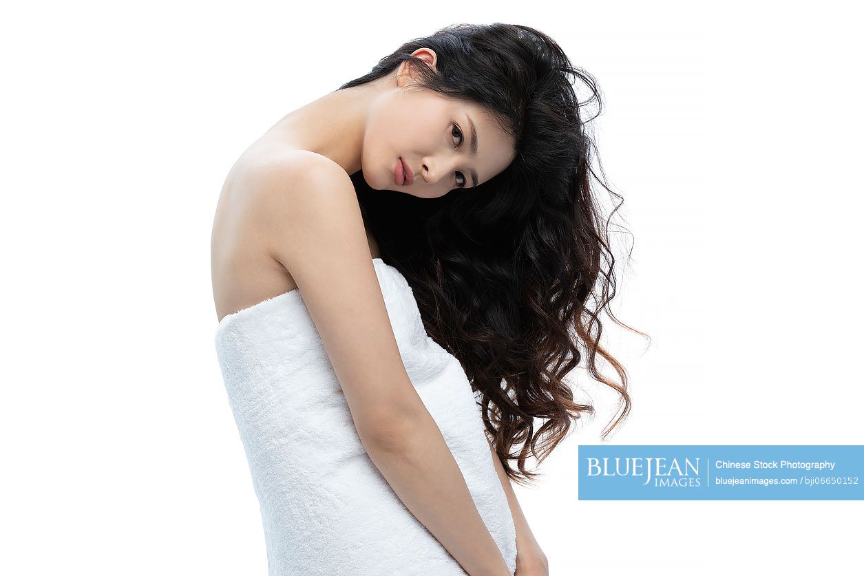 Beautiful young Chinese woman wrapped in towel