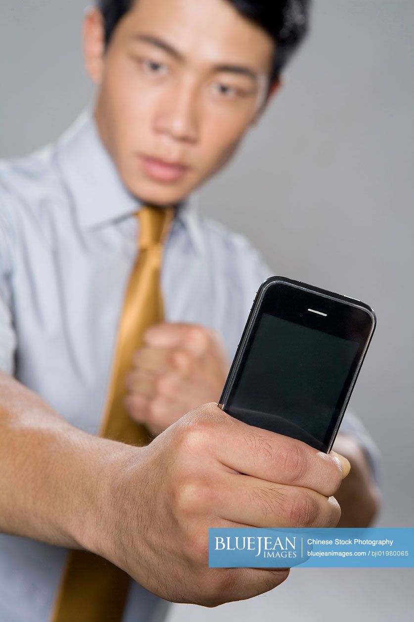 Chinese businessman holding iPhone