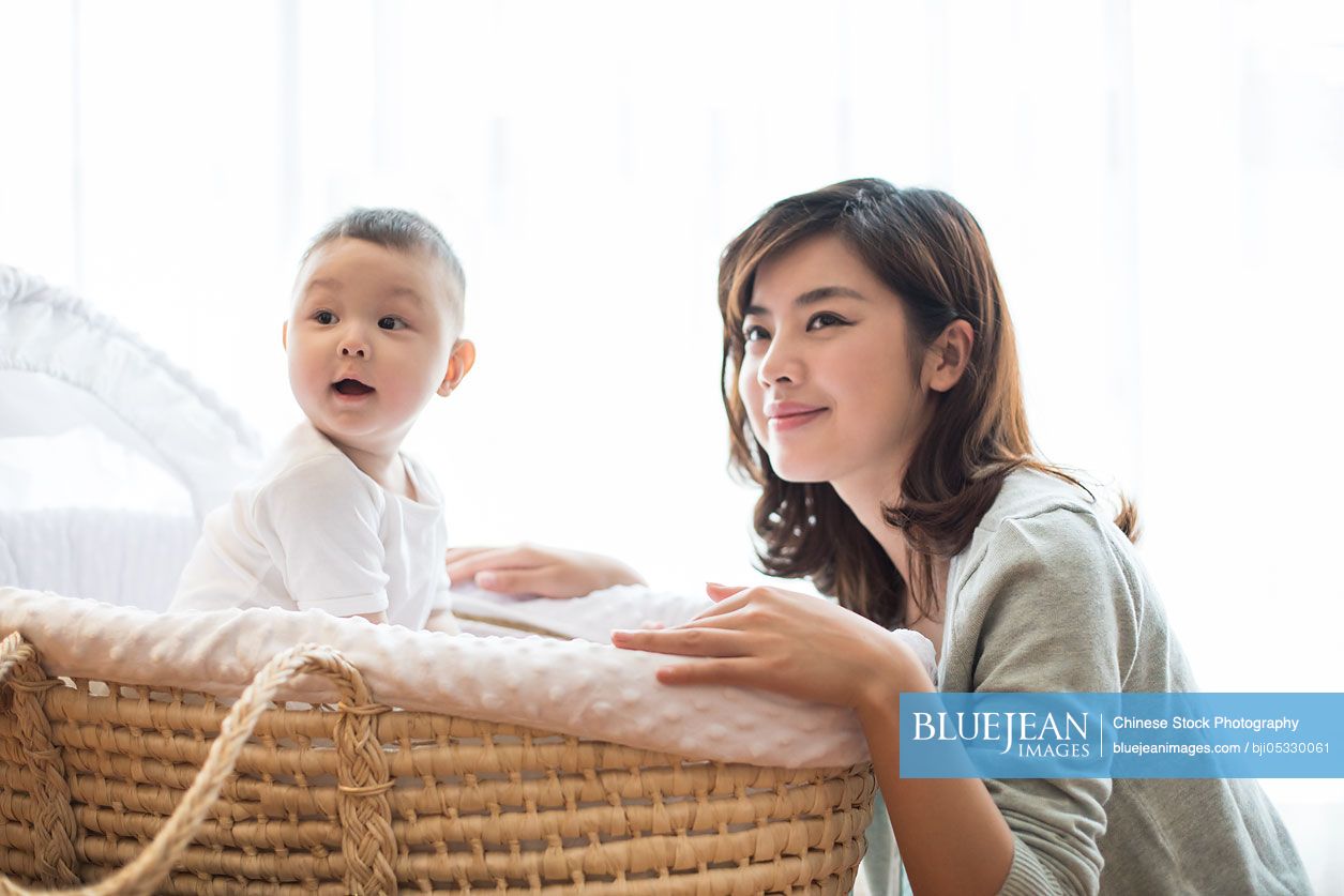 Happy Chinese mother and cute baby at home