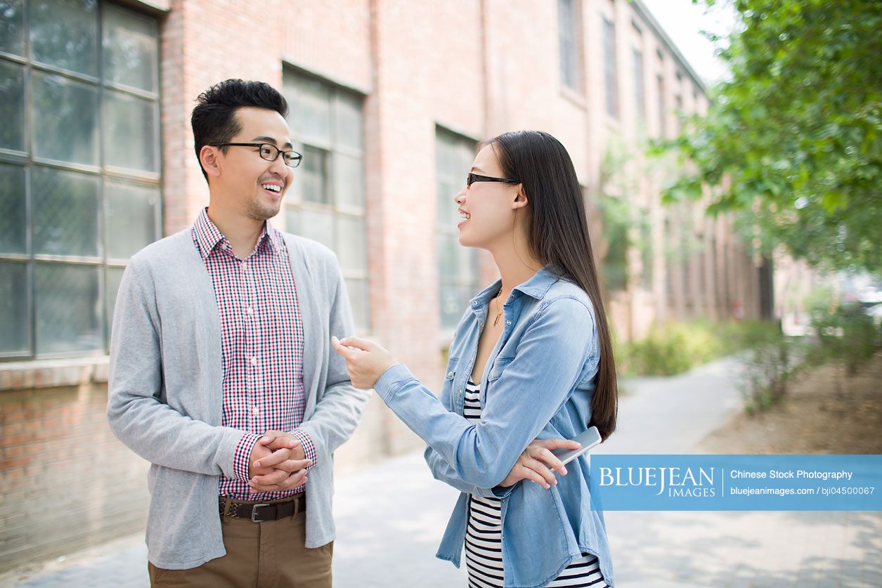 Chinese business partners in cultural industry talking