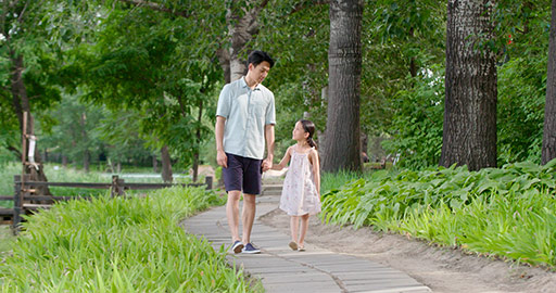 Happy Chinese father and daughter walking in park,4K