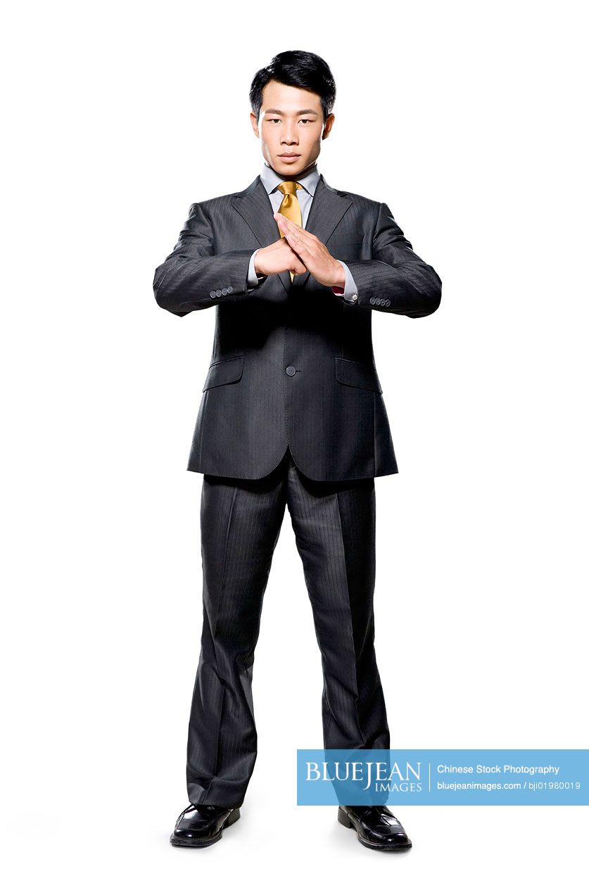 Chinese businessman using hands to greet on white background