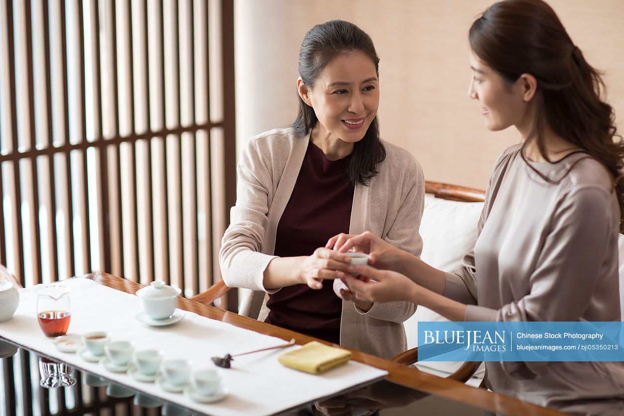 Mature Chinese woman performing tea ceremony