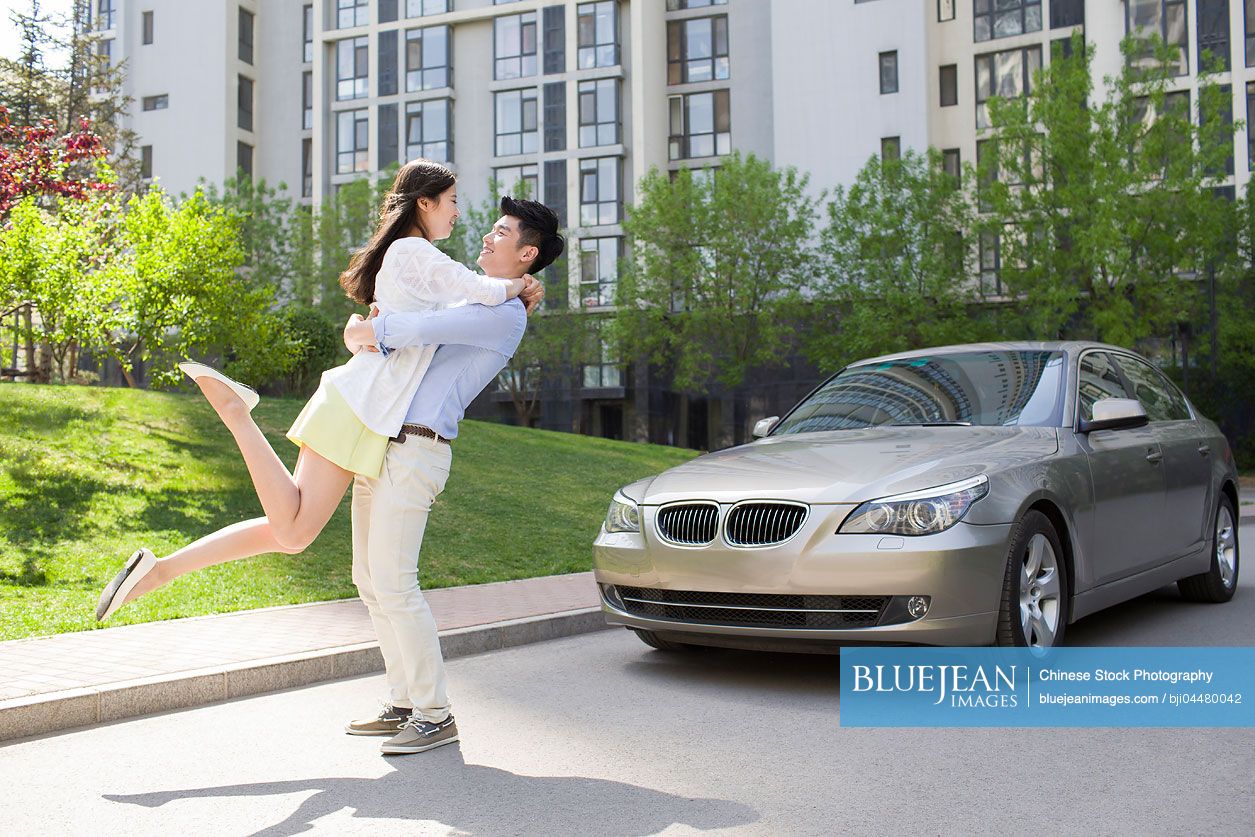 Happy young Chinese couple embracing
