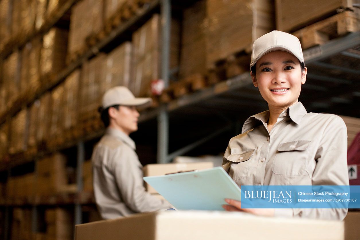 Chinese warehouse workers doing inventory