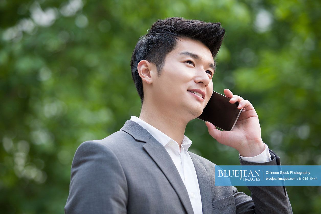 Young Chinese businessman talking on the phone