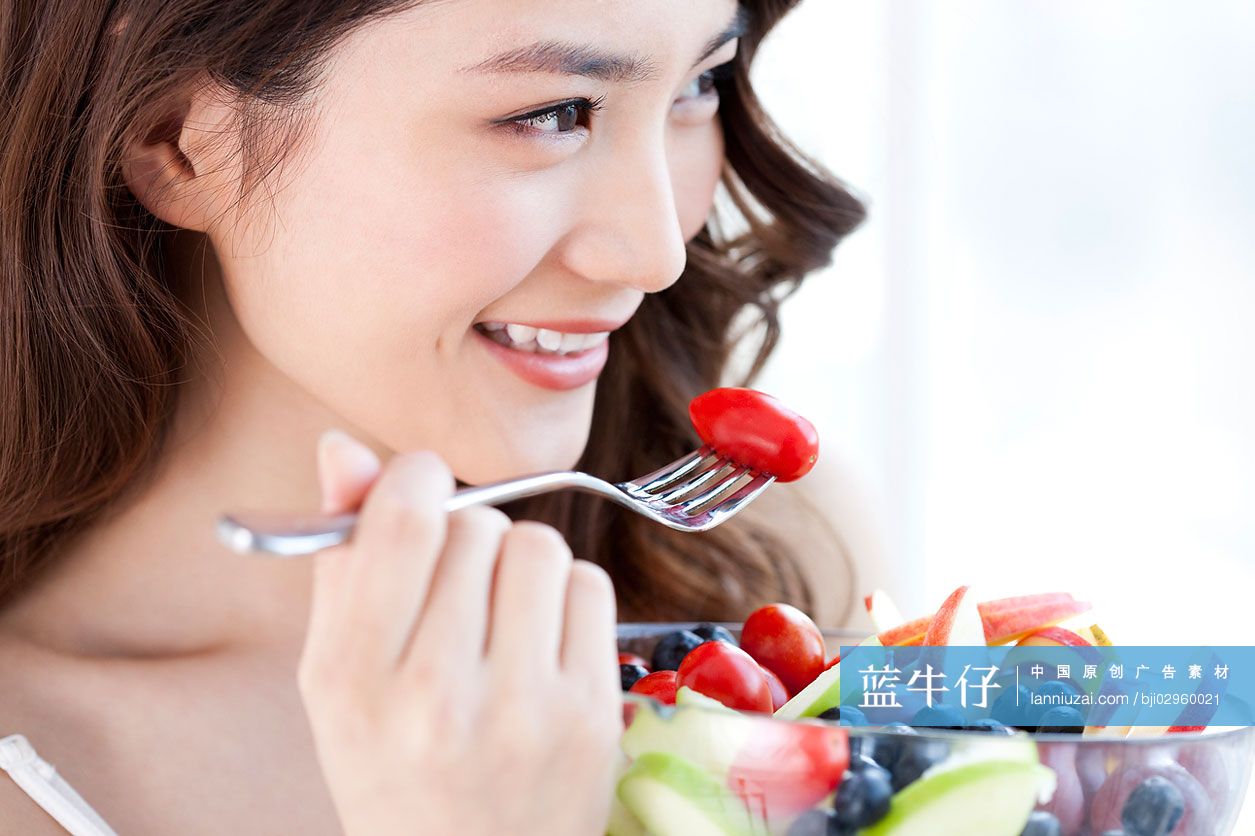 吃水果沙拉的青年女子