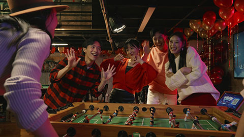 Happy young Chinese friends playing table football,4K