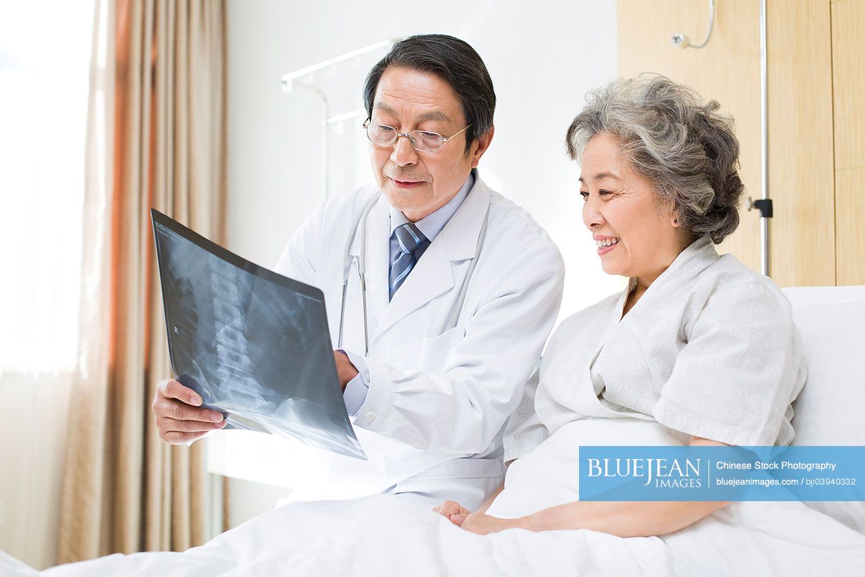 Chinese doctor showing X-ray image to patient