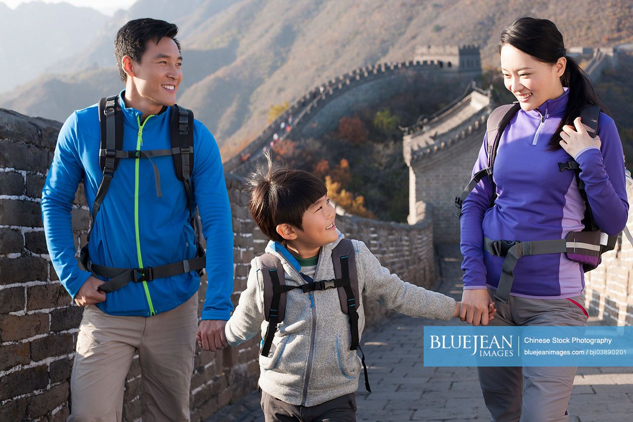 Young Chinese family enjoying autumn outing on Great Wall