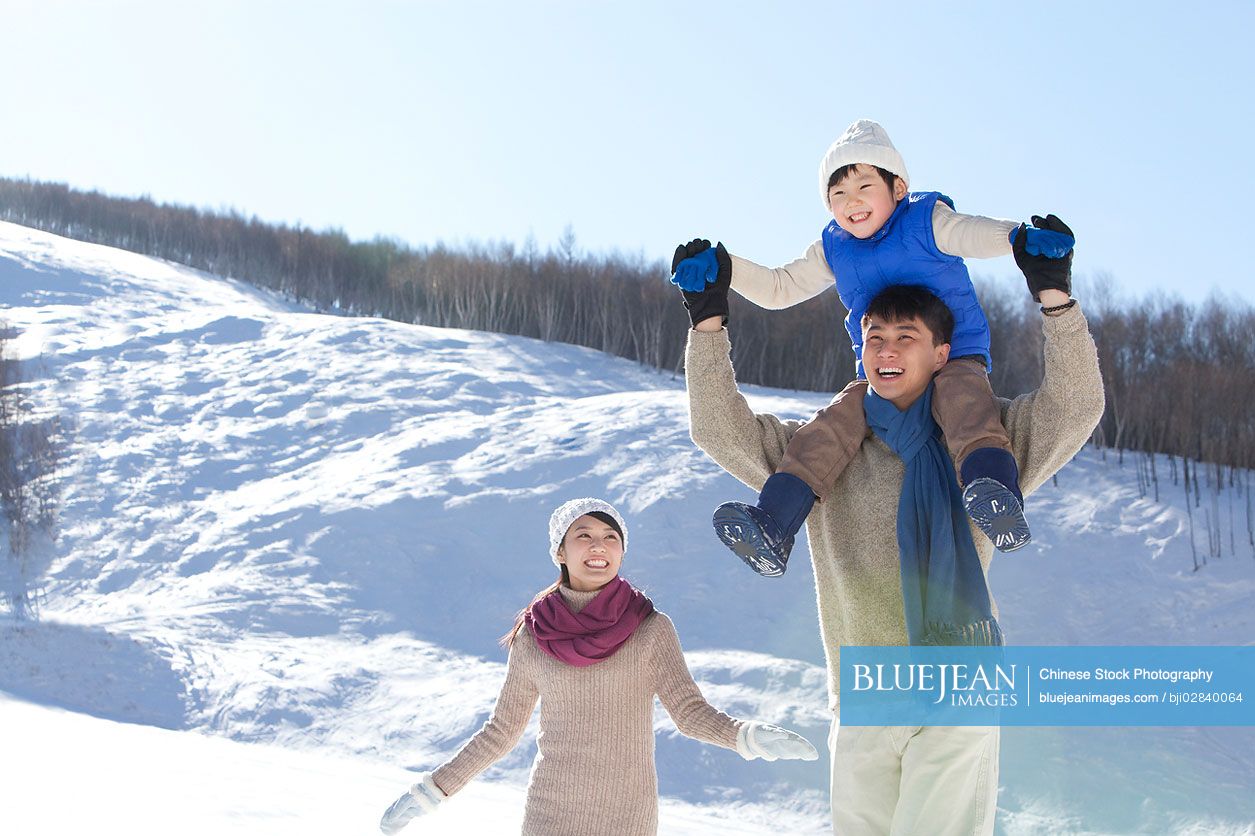 Chinese family having fun in snow