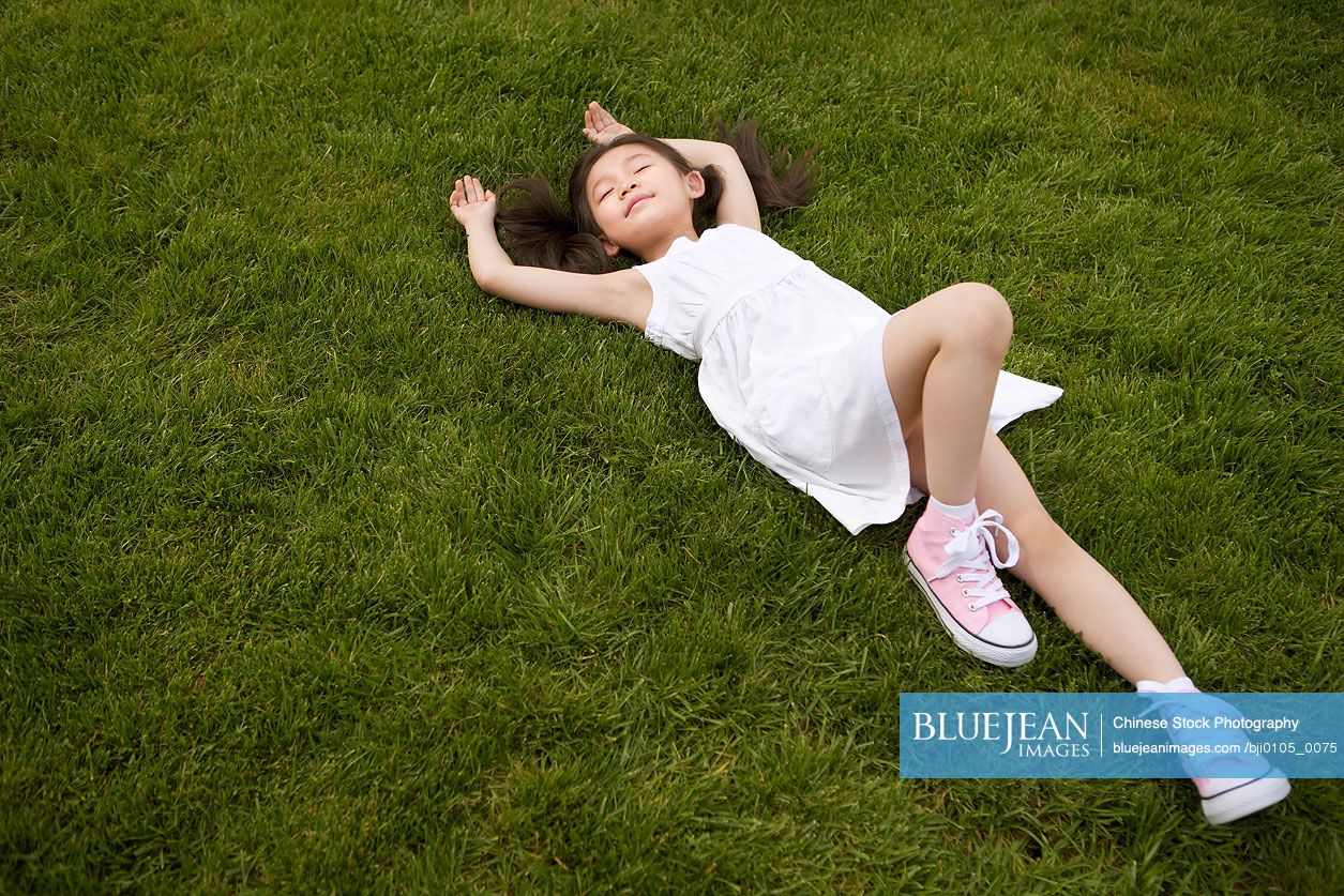 Young Chinese Girl Laying In Park