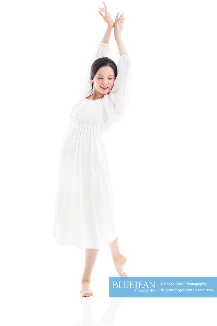 Young pregnant Chinese woman dancing