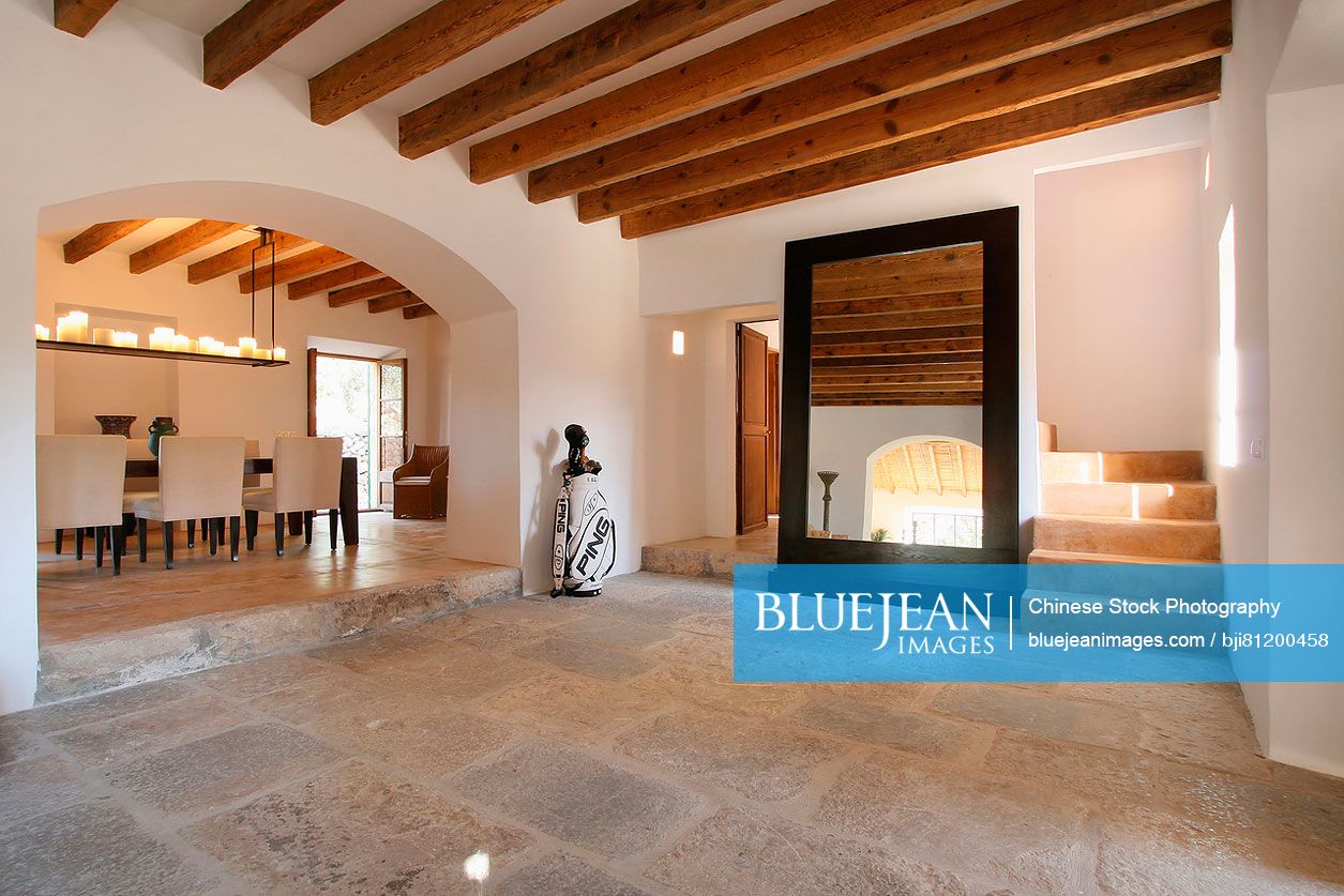 Tile floor and wooden ceiling beams in entry of Spanish villa