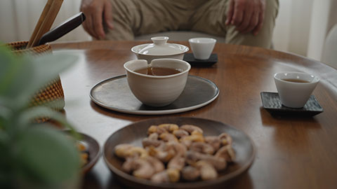 Cheerful senior Chinese couple drinking tea at home,4K