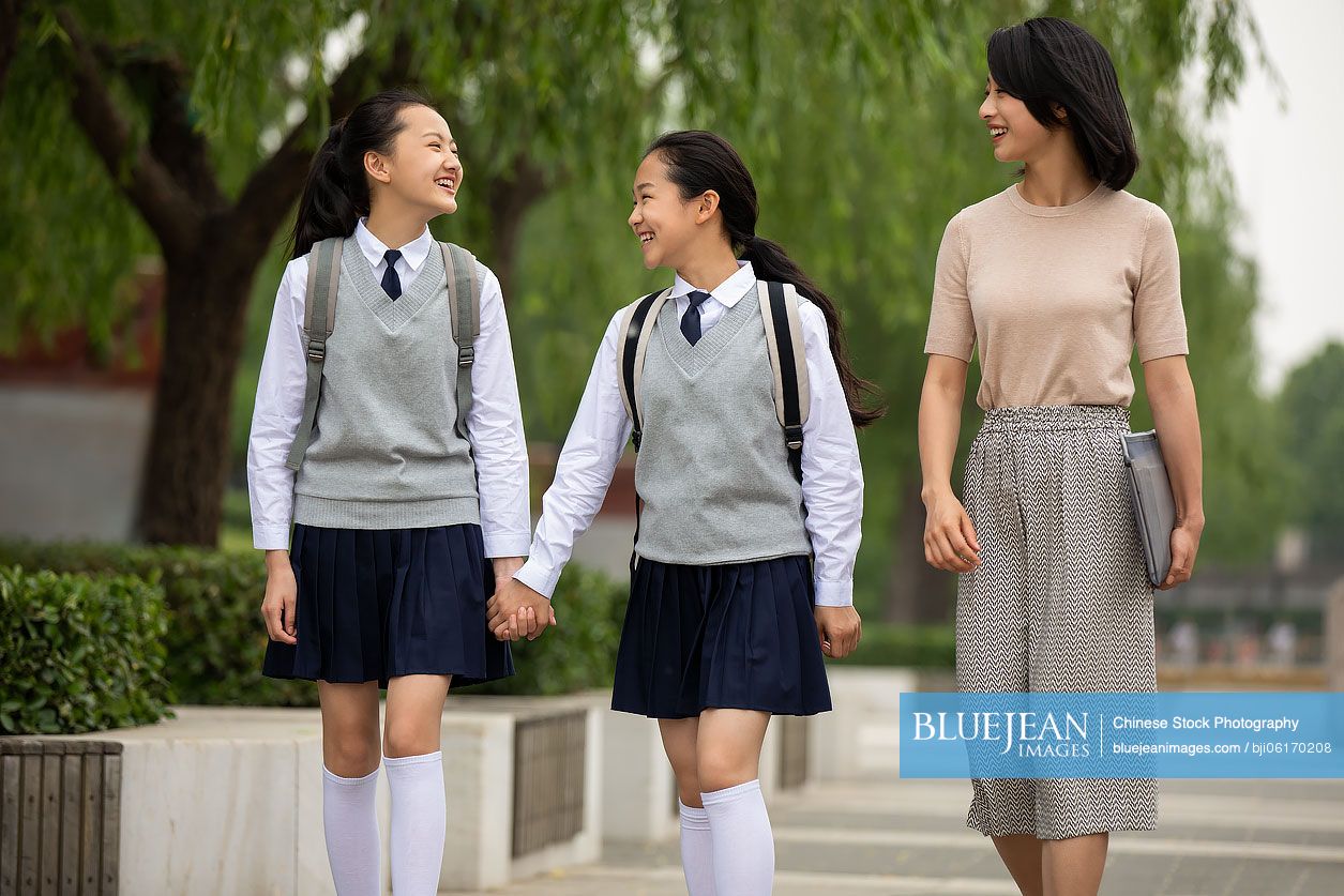 Chinese teacher talking with student on campus