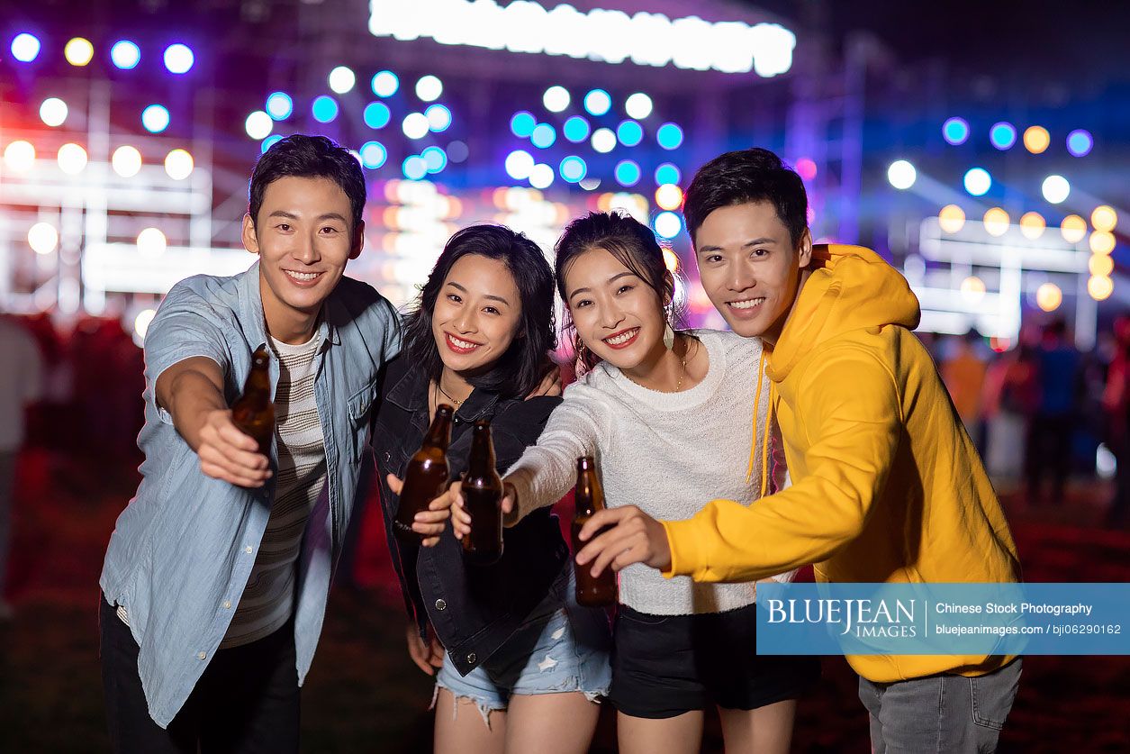 Happy young Chinese friends at music festival
