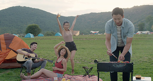 Happy young Chinese friends having a picnic outdoors,4K
