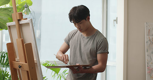Young Chinese man painting at home,4K