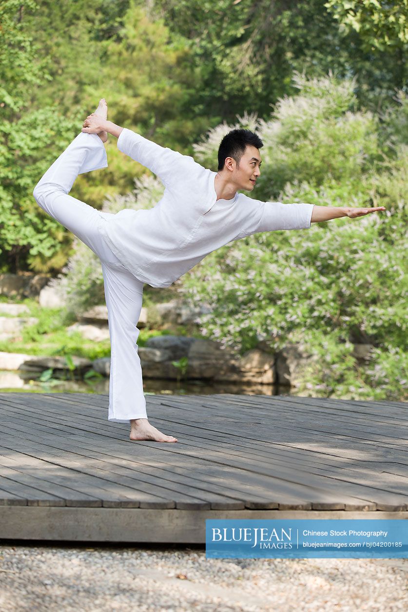 Young Chinese man practicing yoga