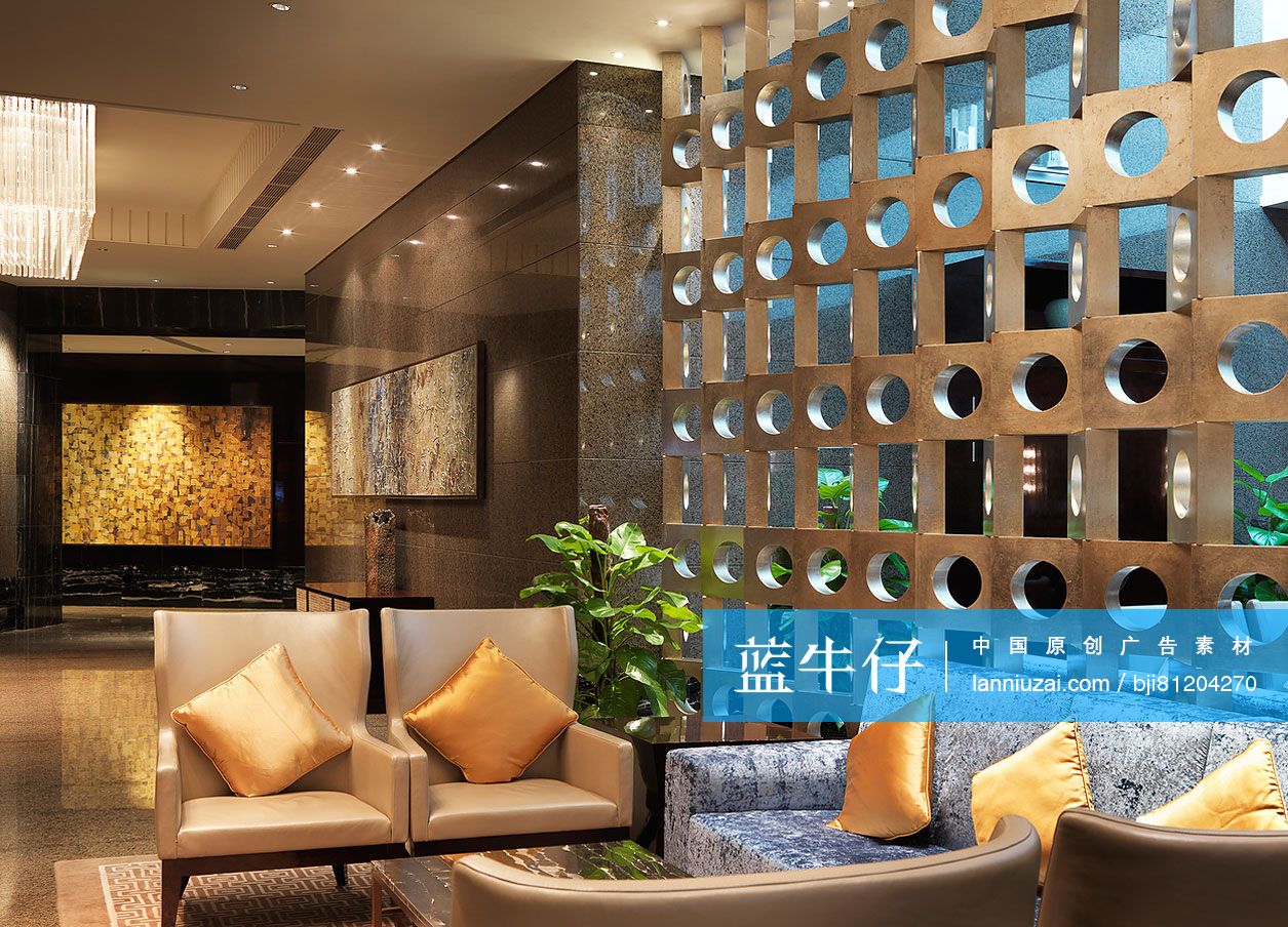 Seating furniture in lobby with wall decal hallway in background at a hotel